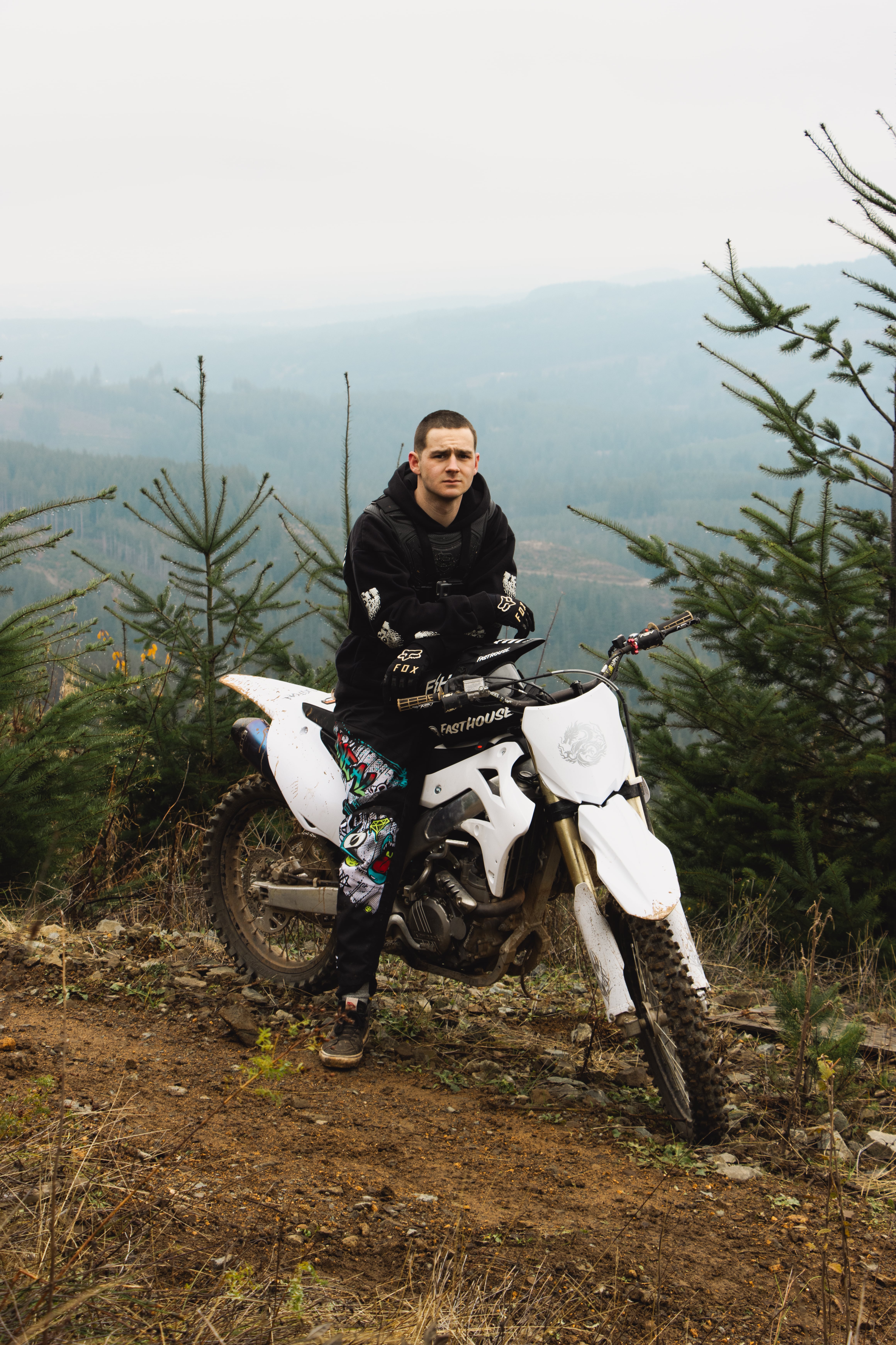Man sitting on a dirt bike outdoors