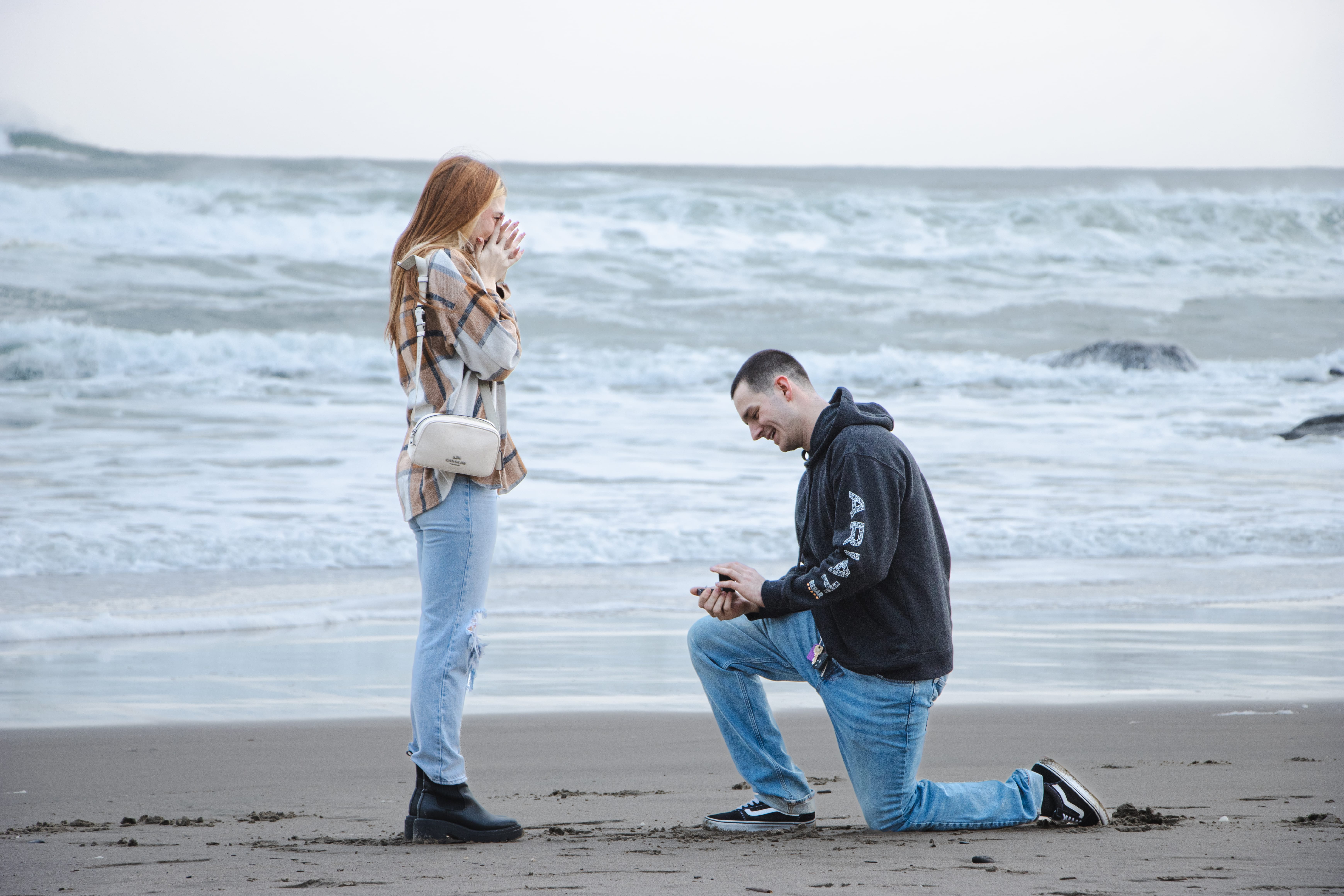 Marriage proposal on a beach at sunset